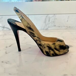 Christian Louboutin slingback pump in a leopard or tiger-print patent leather